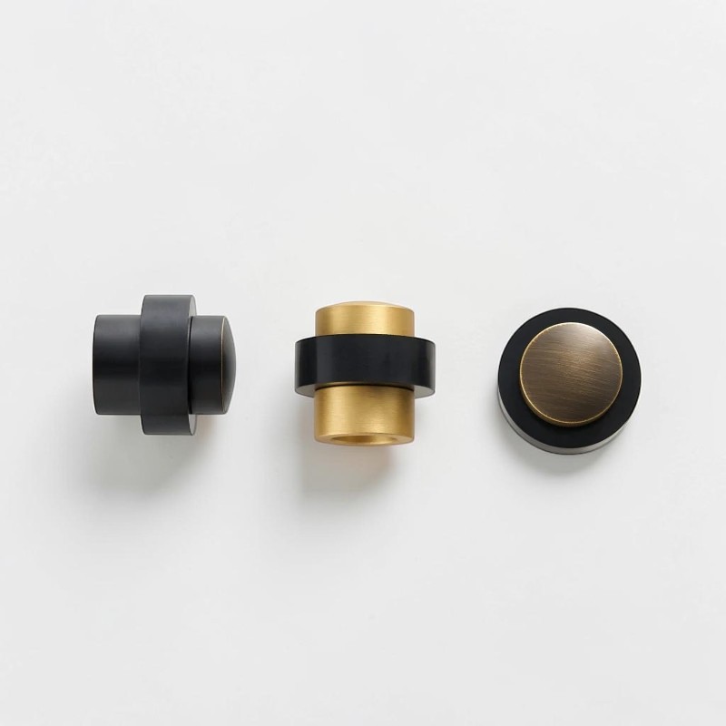 Floor mounted door stops in Black Brass, Brushed Brass and Aged Brass with black rubber bumpers